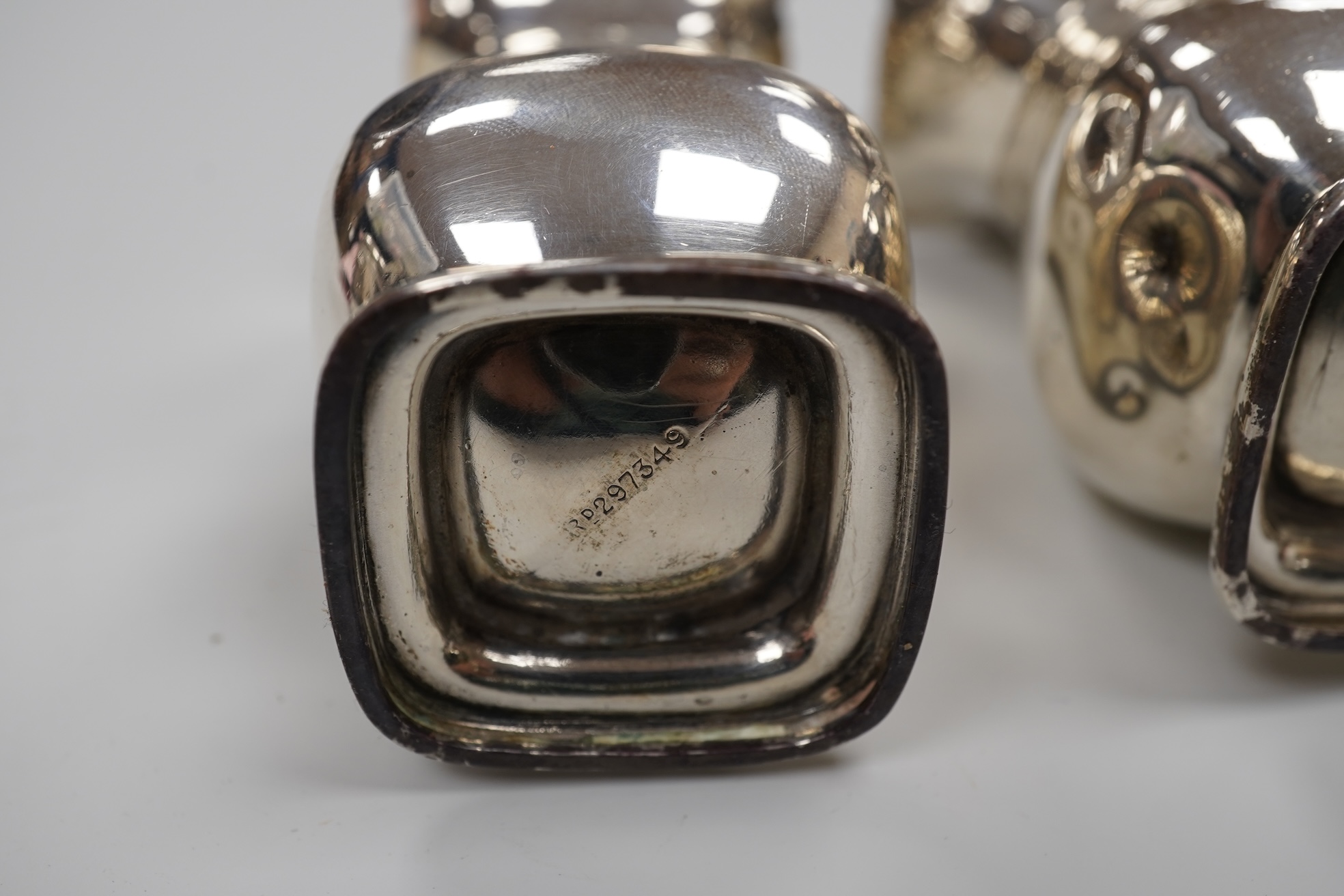 A George V silver drum mustard by Mappin & Webb, Birmingham, 1923, height 71mm, with associated spoon, together with a pair of George V silver pepperettes, Adie Brothers, Birmingham, 1923.